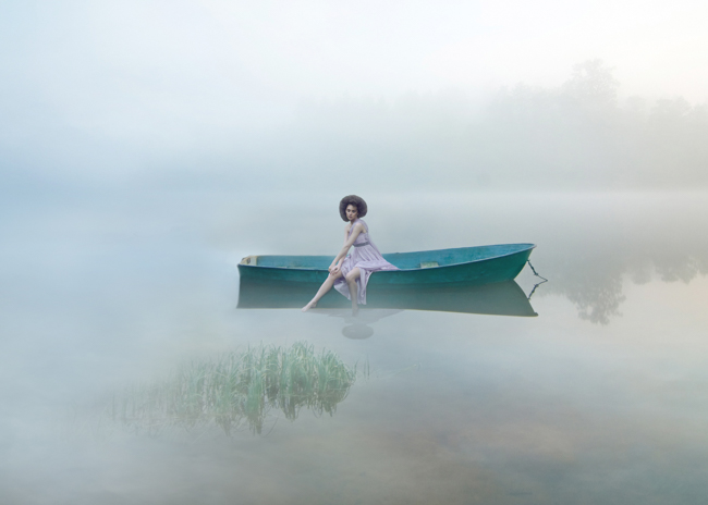 conceptual photography fine art of woman sitting in boat in foggy ice water