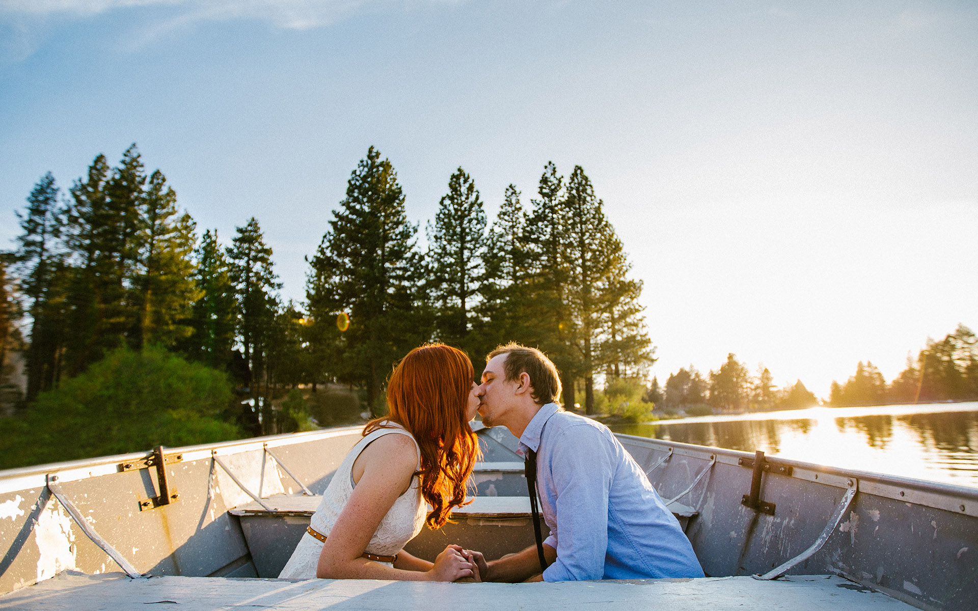 couple kissing at green valley lake sunset engagement photography